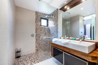 a bathroom with a sink and a shower at CoolHouses Algarve, Luz 2 bed elegant flat, private pool & garden, SPA facilities, Mar da Luz 19 in Luz