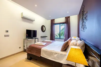a table with two chairs and a bottle of wine on a balcony at CoolHouses Algarve, Luz 2 bed elegant flat, private pool & garden, SPA facilities, Mar da Luz 19 in Luz