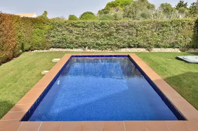 a living room with a couch and a table at CoolHouses Algarve, Luz 2 bed elegant flat, private pool & garden, SPA facilities, Mar da Luz 19 in Luz