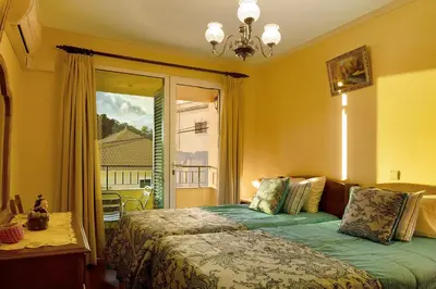 a bedroom with a large bed and a window at Palheiro Residence Familiar 2 in Funchal