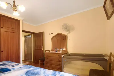 a bedroom with a bed and a sink and a mirror at Palheiro Residence Familiar 1 in Funchal