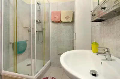 a bathroom with a sink and a bath tub at Palheiro Residence Familiar 1 in Funchal