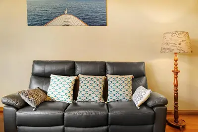 a living room with a couch and a table at Palheiro Residence Vista Mar in Funchal