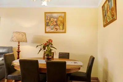 a dining room with a wooden table and chairs at Palheiro Residence Vista Mar in Funchal