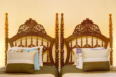 two beds with wooden head boards with pillows at Palheiro Residence Vista Mar in Funchal