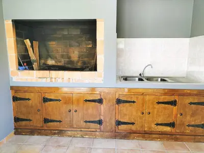 a kitchen with wooden cabinets and a sink at Villa Fanny in Ribeira Brava