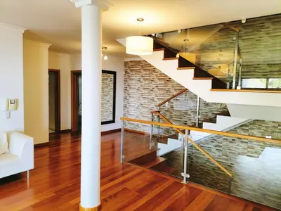 a staircase in a living room with a brick wall at Villa Fanny in Ribeira Brava