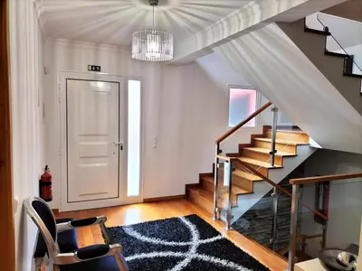 a living room with a staircase and a stair case at Villa Fanny in Ribeira Brava