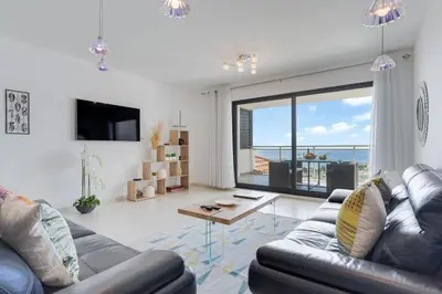a living room with a couch and a table at Apartment Nata by Holiday Rental Madeira in Caniço
