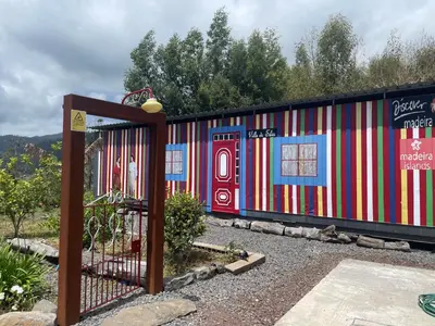 a colorful building with a gate in a yard at Villa da Silva (Heated Pool and Private Parking) in Arco da Calheta