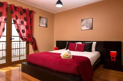 a bedroom with a bed with a teddy bear on it at KING´S HOUSE (Sea View and Indoor BBQ) in Estreito da Calheta