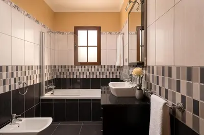 a black and white bathroom with two sinks and a tub at KING´S HOUSE (Sea View and Indoor BBQ) in Estreito da Calheta