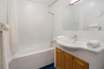 a bedroom with two beds with towels on the floor at Casa de férias a 75 metros da praia in Campo de Baixo