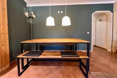 a table in a room with two pendant lights at Country Villa work&relax in Lagos