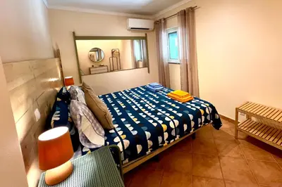 a bedroom with a bed and a mirror and a chair at Country Villa work&relax in Lagos