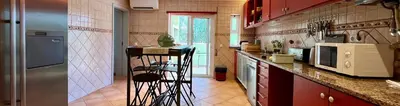 a kitchen with red cabinets and a counter at Country Villa work&relax in Lagos