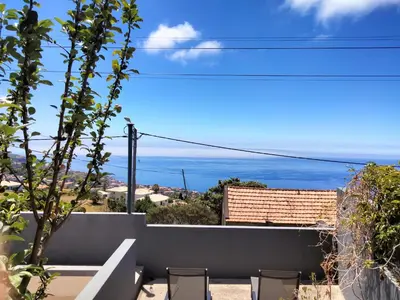 a view of the ocean from the balcony of a house at A Casa Valentina - Estudio vista panorâmica para o mar in Estreito da Calheta