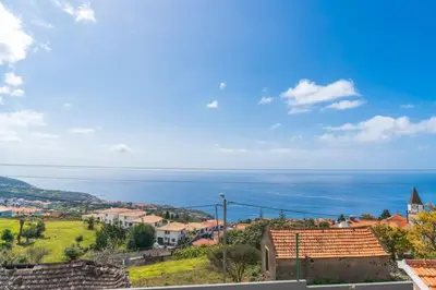 a view of a town with the ocean in the background at A Casa Valentina - Estudio vista panorâmica para o mar in Estreito da Calheta