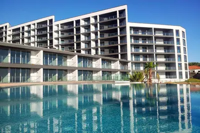 a large apartment building with a large pool of water at Lexus Avenue by LovelyStay in Funchal