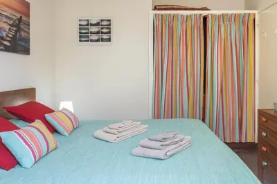 a bedroom with a bed with towels on it at Formosa Beach in Porto Santo