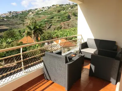 a balcony with chairs and a view of a mountain at Formosa Sunset in Funchal