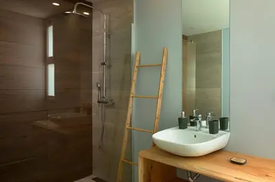 a bathroom with a sink and a shower at King´s Paradise (Heated Pool and Sea View) in Estreito da Calheta
