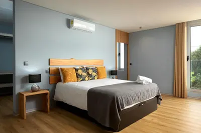 a bedroom with a large bed and a window at King´s View (Heated Pool and Sea View) in Estreito da Calheta