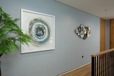 a white wall with a painting on a wall at King´s View (Heated Pool and Sea View) in Estreito da Calheta