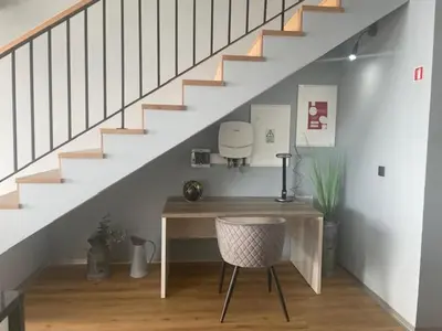 a desk with a chair in a room with stairs at King´s View (Heated Pool and Sea View) in Estreito da Calheta