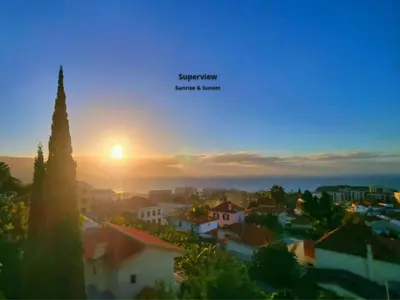 a bedroom with a bed and a large window at Spacious Summer Fresh Family Apartment with Panoramic Sea Views in Funchal in Funchal