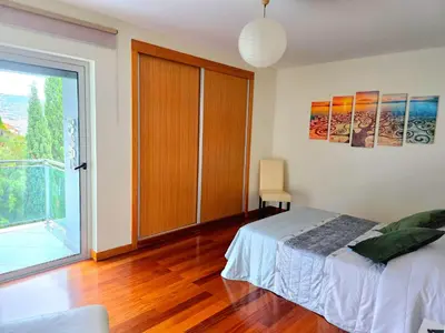a bottle of wine sitting on a table with wine glasses at Spacious Summer Fresh Family Apartment with Panoramic Sea Views in Funchal in Funchal