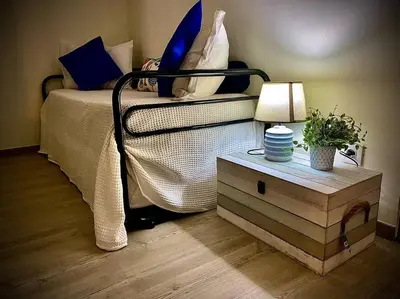 a bedroom with a bed and a table with a lamp at Casa de Praia in Almagreira