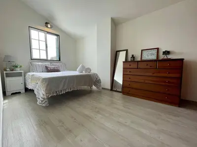 a bedroom with a bed and a wooden dresser at Casa de Praia in Almagreira