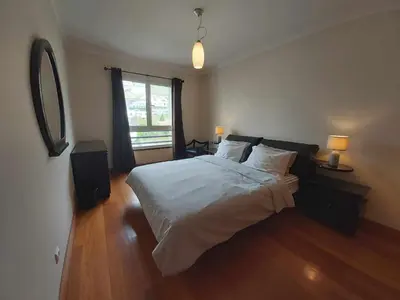 a bedroom with a large bed and a window at Comfy and Charming Palace in Funchal