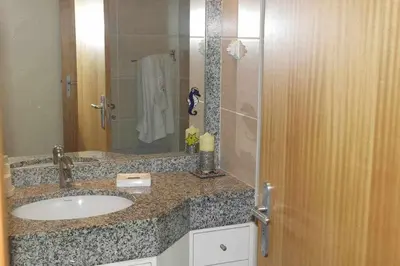 a bathroom with a sink and a shower with a mirror at Comfy and Charming Palace in Funchal