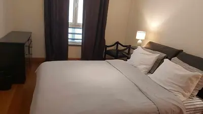 a large white bed in a room with a window at Comfy and Charming Palace in Funchal