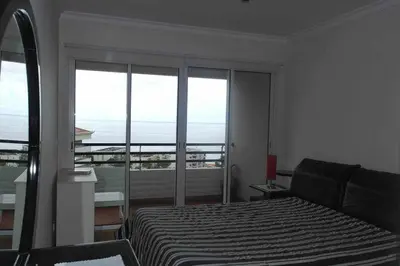 a bedroom with a bed and a view of the ocean at Comfy and Charming Palace in Funchal