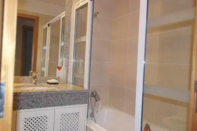 a bathroom with a shower and a tub and a sink at Comfy and Charming Palace in Funchal