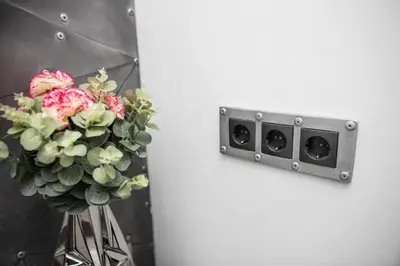 a vase of flowers next to a wall at Madeira Loft I - City Center in Funchal