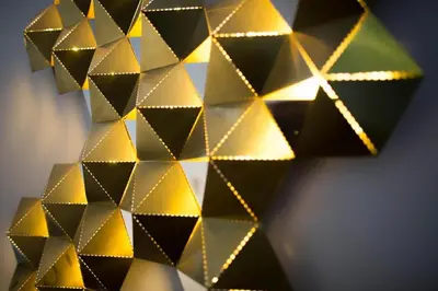 a bunch of gold and black diamonds on a wall at Madeira Loft I - City Center in Funchal