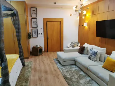 a living room with a white couch and a tv at Madeira Loft I - City Center in Funchal