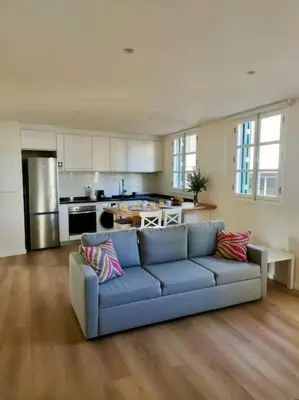 a living room with a blue couch in a kitchen at Seven Funchal Apartments in Funchal