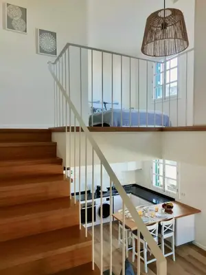 a staircase in a house with a bed at Seven Funchal Apartments in Funchal