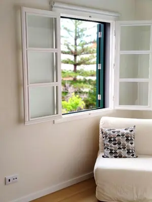 a white couch sitting in front of a window at Seven Funchal Apartments in Funchal