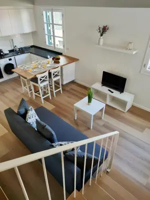 a living room and kitchen with a couch and a table at Seven Funchal Apartments in Funchal