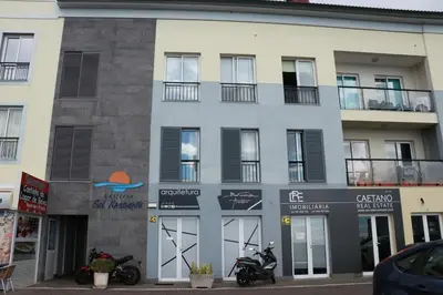 a building with a motorcycle parked in front of it at Casa do Sol in Ponta do Sol