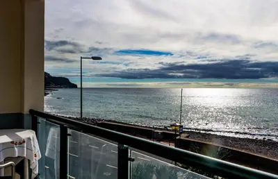 a view of the ocean from a balcony at Casa do Sol in Ponta do Sol