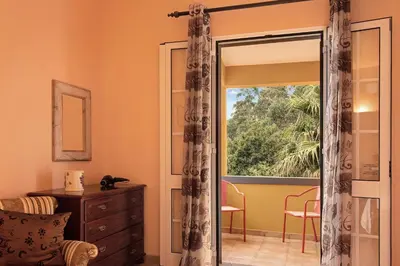 a room with a sliding glass door with a window at Casa Catarina in Santo da Serra