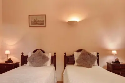 a bedroom with two beds and two night stands at Casa Catarina in Santo da Serra