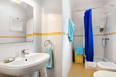 a bathroom with a sink and a toilet and a shower at Apartamento A Quinta Porto Santo in Campo de Baixo